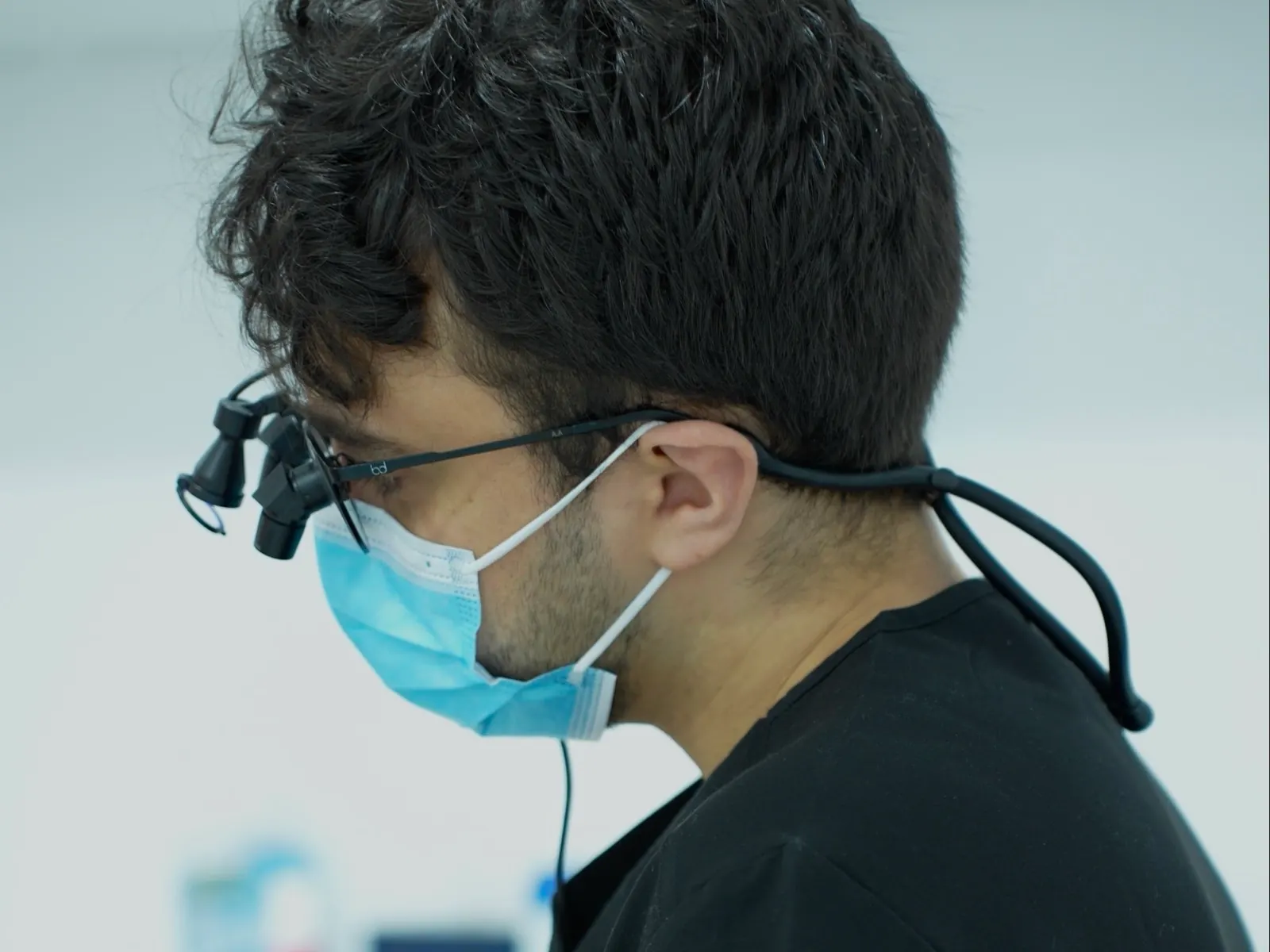 A dentist at Dentist at Underwood working with magnifying loupes